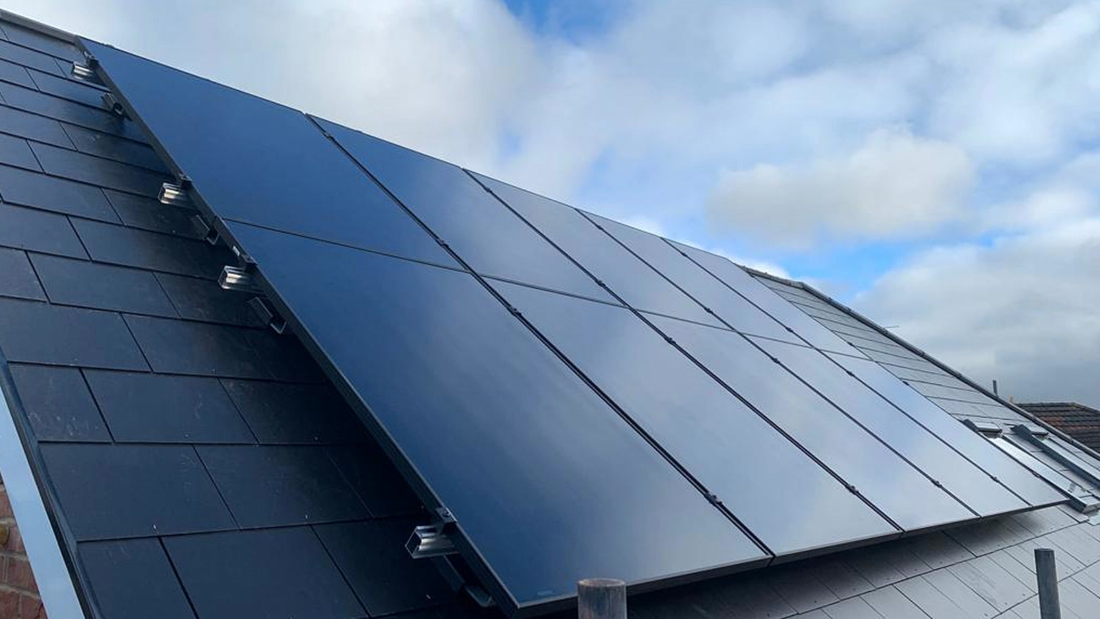 Black monocrystalline solar panels installed on a roof
