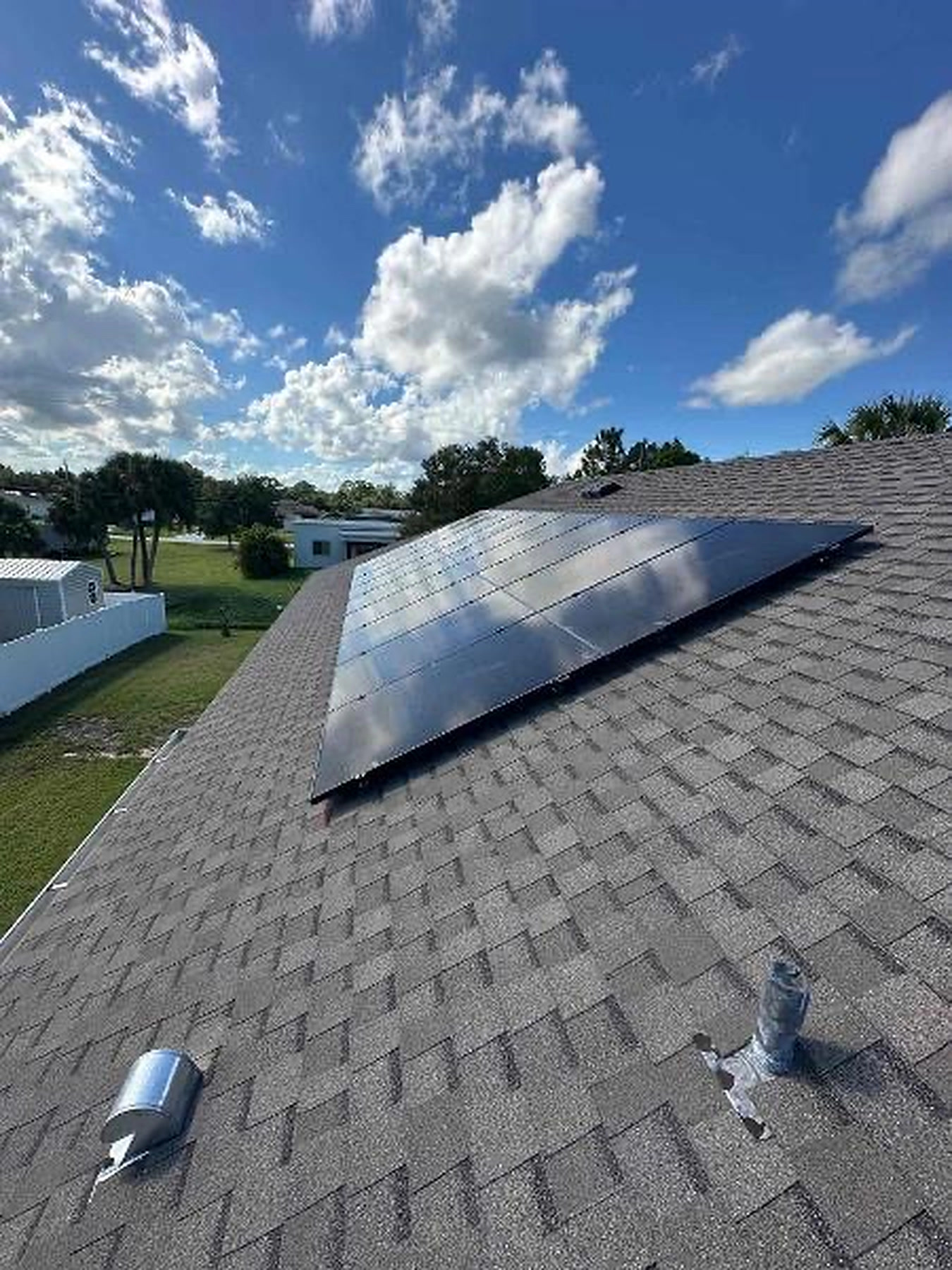 Solar panel array on a rooftop under a clear blue sky