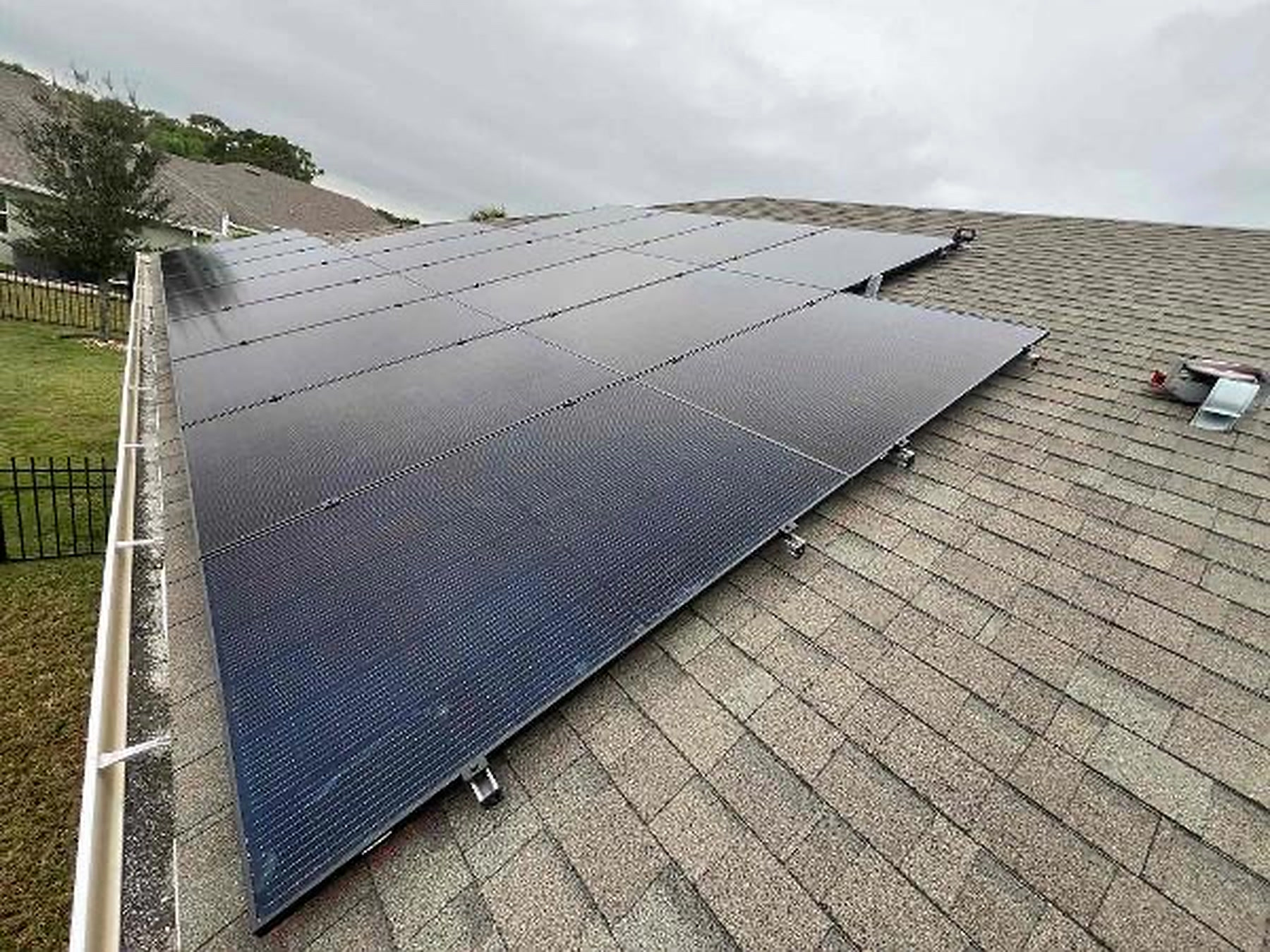 Full rooftop solar panel array installed on a shingle roof